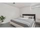 A bedroom with a modern gray aesthetic, minimalist decor, and gray carpeting at 4518 Elm Ct, Denver, CO 80211