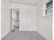 A bright bedroom with a closet and built-in storage features neutral carpet and natural light from a window at 4518 Elm Ct, Denver, CO 80211