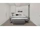 A bedroom with a modern gray aesthetic, minimalist decor, and gray carpeting at 4518 Elm Ct, Denver, CO 80211