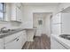 Cozy kitchen with white cabinets, stainless steel sink, and modern appliances at 4518 Elm Ct, Denver, CO 80211