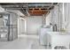 Basement laundry room with utility sink and vintage furnace at 4518 Elm Ct, Denver, CO 80211