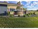 Backyard patio featuring a hot tub, outdoor kitchen area, and lush landscaping for relaxation and entertainment at 15945 Delta Ct, Brighton, CO 80603