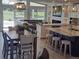 Open-concept living space with large windows, an eat-in kitchen island, dining table, and comfortable seating at 15945 Delta Ct, Brighton, CO 80603