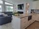 Comfortable living area with a modern fireplace, large windows, and a kitchen island at 15945 Delta Ct, Brighton, CO 80603