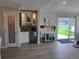 Bright living room area featuring a bar, hardwood flooring, and sliding glass door to the patio at 15945 Delta Ct, Brighton, CO 80603