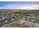 Expansive aerial view of a residential neighborhood featuring manicured lawns, winding streets, and mountain views at 3480 Mount Powell Dr, Broomfield, CO 80023