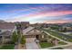 Aerial view of a house with a manicured lawn nestled in a neighborhood with sunset sky at 3480 Mount Powell Dr, Broomfield, CO 80023