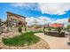 Spacious backyard with a patio seating area, lush green lawn, and a charming wooden fence at 3480 Mount Powell Dr, Broomfield, CO 80023