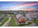 Charming backyard with patio seating and a view of the neighborhood at dusk at 3480 Mount Powell Dr, Broomfield, CO 80023