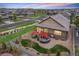 Lovely backyard with a stone patio, outdoor kitchen, tasteful landscaping, and views of a quiet neighborhood at 3480 Mount Powell Dr, Broomfield, CO 80023