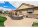 Backyard with a circular patio, outdoor seating, stainless steel grill, and beautiful landscaping at 3480 Mount Powell Dr, Broomfield, CO 80023