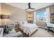 Cozy bedroom with a neutral color scheme, ceiling fan, and plenty of natural light from the window at 3480 Mount Powell Dr, Broomfield, CO 80023