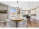 Dining area with chandelier and a view to kitchen island and backyard at 3480 Mount Powell Dr, Broomfield, CO 80023