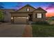 Charming single-Gathering home with a well-manicured lawn, stone accents, and a two-car garage under a colorful sky at 3480 Mount Powell Dr, Broomfield, CO 80023