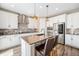 Elegant kitchen featuring white cabinets, stainless steel appliances, a center island, and stylish backsplash at 3480 Mount Powell Dr, Broomfield, CO 80023