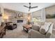 Cozy living room featuring a stone accent wall, a fireplace, comfortable seating, and natural lighting at 3480 Mount Powell Dr, Broomfield, CO 80023