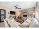 Comfortable living room featuring a stone fireplace, modern fan, and lots of natural light at 3480 Mount Powell Dr, Broomfield, CO 80023