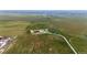 Expansive aerial view of a rural property with well-maintained buildings and lush green fields at 46122 County Road 53, Bennett, CO 80102
