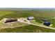 Expansive aerial view of the property showcasing its well-kept structures and vast land at 46122 County Road 53, Bennett, CO 80102