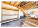 Partially finished basement featuring stairs and a work area at 46122 County Road 53, Bennett, CO 80102