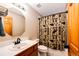 Small bathroom with a single sink vanity, toilet, and bathtub with shower at 46122 County Road 53, Bennett, CO 80102