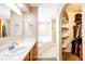 Bathroom featuring a soaking tub, separate shower, and a walk-in closet at 46122 County Road 53, Bennett, CO 80102