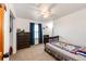 bedroom with a crib, dresser and ceiling fan at 46122 County Road 53, Bennett, CO 80102