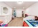 Bedroom featuring carpet floors, white furniture, and access to closet and laundry room at 46122 County Road 53, Bennett, CO 80102