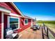 Outdoor deck featuring a dining set and comfortable seating, perfect for enjoying the view at 46122 County Road 53, Bennett, CO 80102