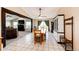 Open-concept dining room with hardwood floors and plenty of natural light and a nearby fireplace at 46122 County Road 53, Bennett, CO 80102