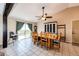 Well-lit dining area with a large wooden table, seating for six, and stylish decor at 46122 County Road 53, Bennett, CO 80102