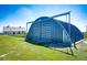 Spacious steel garage with a roll-up door, offering ample storage and shelter on a well-maintained property at 46122 County Road 53, Bennett, CO 80102