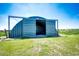 Open steel garage providing easy access and plenty of room for vehicles or equipment at 46122 County Road 53, Bennett, CO 80102