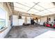 Spacious three car garage with side door, overhead lighting, and ample storage space at 46122 County Road 53, Bennett, CO 80102