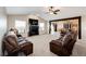 Bright living room features a fireplace, plush seating, and ample natural light at 46122 County Road 53, Bennett, CO 80102