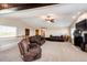 Spacious living room features a fireplace and comfortable brown leather seating at 46122 County Road 53, Bennett, CO 80102