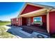 Inviting covered porch with seating, perfect for enjoying peaceful outdoor moments at 46122 County Road 53, Bennett, CO 80102