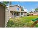 Large backyard with a shed, covered patio, mature trees, and a playset at 3973 S Joplin Way, Aurora, CO 80013