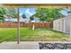 Backyard view with a wood fence, playset, shed, and a grass lawn at 3973 S Joplin Way, Aurora, CO 80013