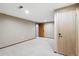 View of the finished basement with neutral carpet and paint, and wood trim at 3973 S Joplin Way, Aurora, CO 80013
