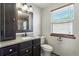 Bathroom with modern dark-stained vanity and a large mirror at 3973 S Joplin Way, Aurora, CO 80013