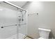 Bathroom featuring a glass-enclosed shower and white toilet with a hardwood-style floor at 3973 S Joplin Way, Aurora, CO 80013