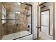 Updated bathroom with a glass-enclosed shower, a tiled tub, and contemporary fixtures at 3973 S Joplin Way, Aurora, CO 80013