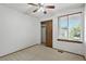 Bedroom with a ceiling fan, window with blinds, and sliding closet doors at 3973 S Joplin Way, Aurora, CO 80013