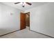 Bedroom featuring neutral walls and carpet, with a closet and wooden door at 3973 S Joplin Way, Aurora, CO 80013