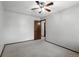 Bedroom featuring neutral walls and carpet, with a closet and wooden door at 3973 S Joplin Way, Aurora, CO 80013