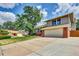 Charming home featuring a two-car garage, a long driveway, and a well-manicured front yard at 3973 S Joplin Way, Aurora, CO 80013
