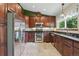 Well-equipped kitchen with stainless steel appliances and dark wood cabinets at 3973 S Joplin Way, Aurora, CO 80013