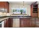 Close up on kitchen counter and cabinets beneath a window with natural light at 3973 S Joplin Way, Aurora, CO 80013