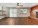 Spacious living room with hardwood floors, fireplace and sliding glass door to outside at 3973 S Joplin Way, Aurora, CO 80013